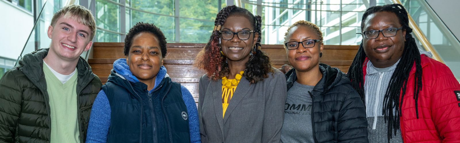 Picture of students and guest speaker at stairwell 