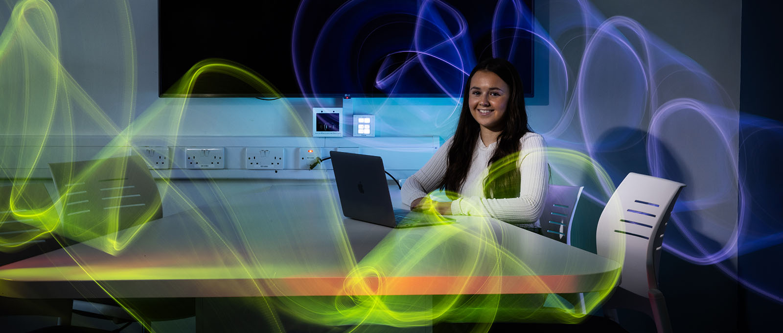 female student sitting in front of computer screen