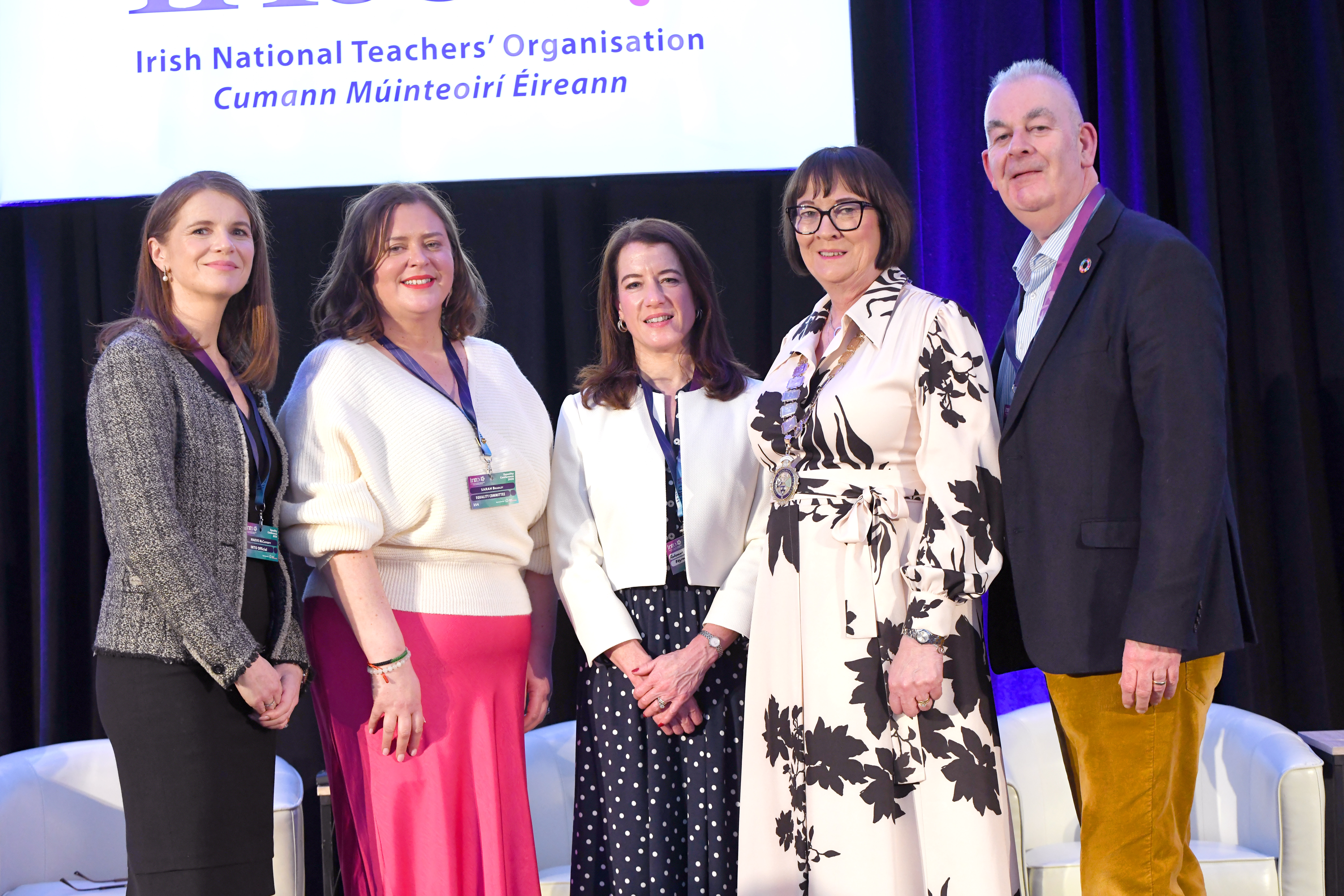 Group photo of five speakers at an INTO conference