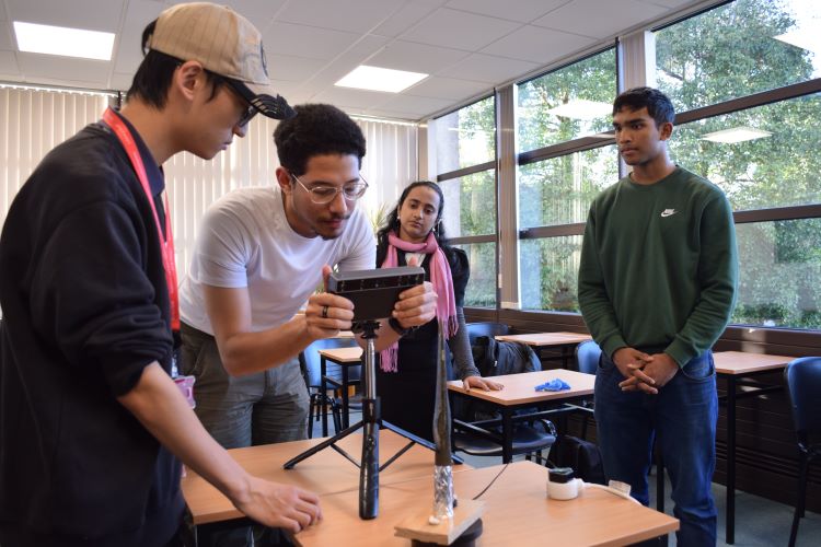 Yousef Konswah and Liu Xiao Yu undertaking a 3-D laser scan of a Late Bronze Age Spearhead in the Discipline of Archaeology
