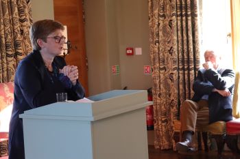 Dr Michelle Comber at launch of festschrift in honour of John Waddell (in background)