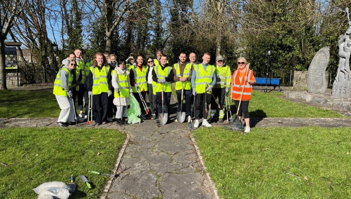 group of students in high vis jackets cleaning up ennis for tidy towns 