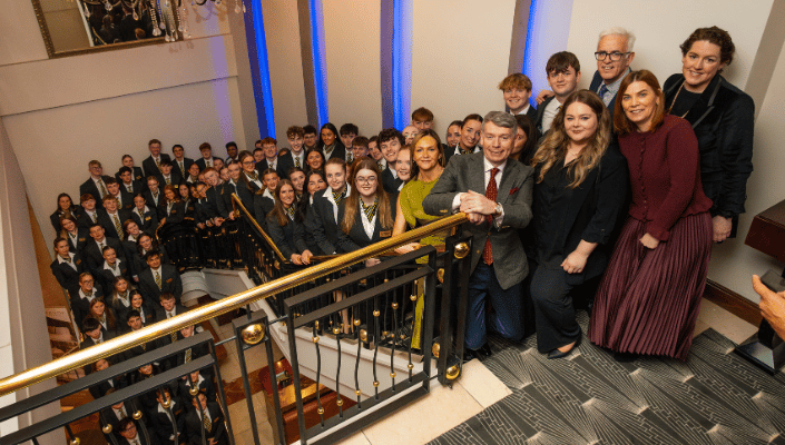 students and staff posing on stairs