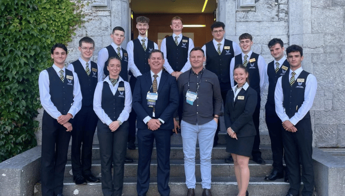 students and staff in uniform outside the Aula in Galway at the TTRA conference
