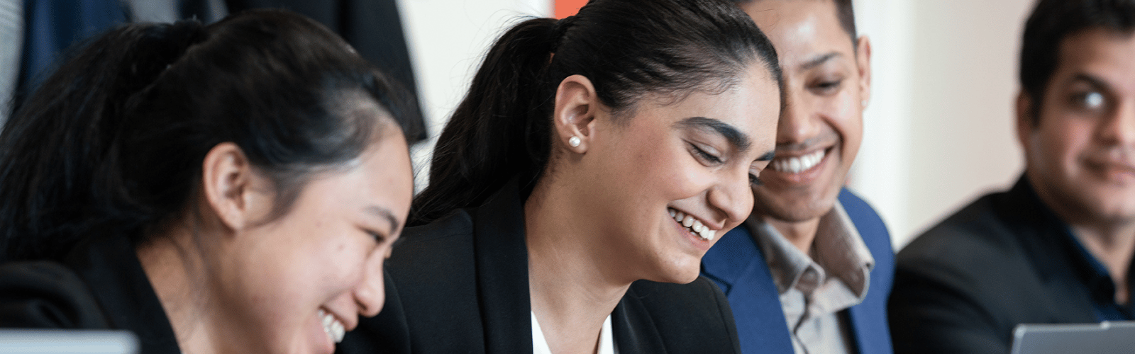 postgraduate students in classroom smiling 