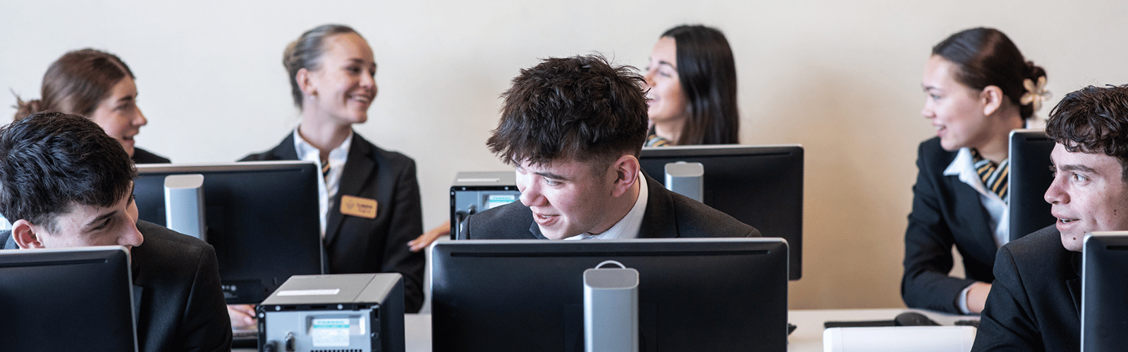 students smiling in computer classroom 