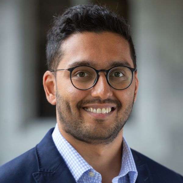 A headshot of Prateek Dixit, in colour, with a blurred background